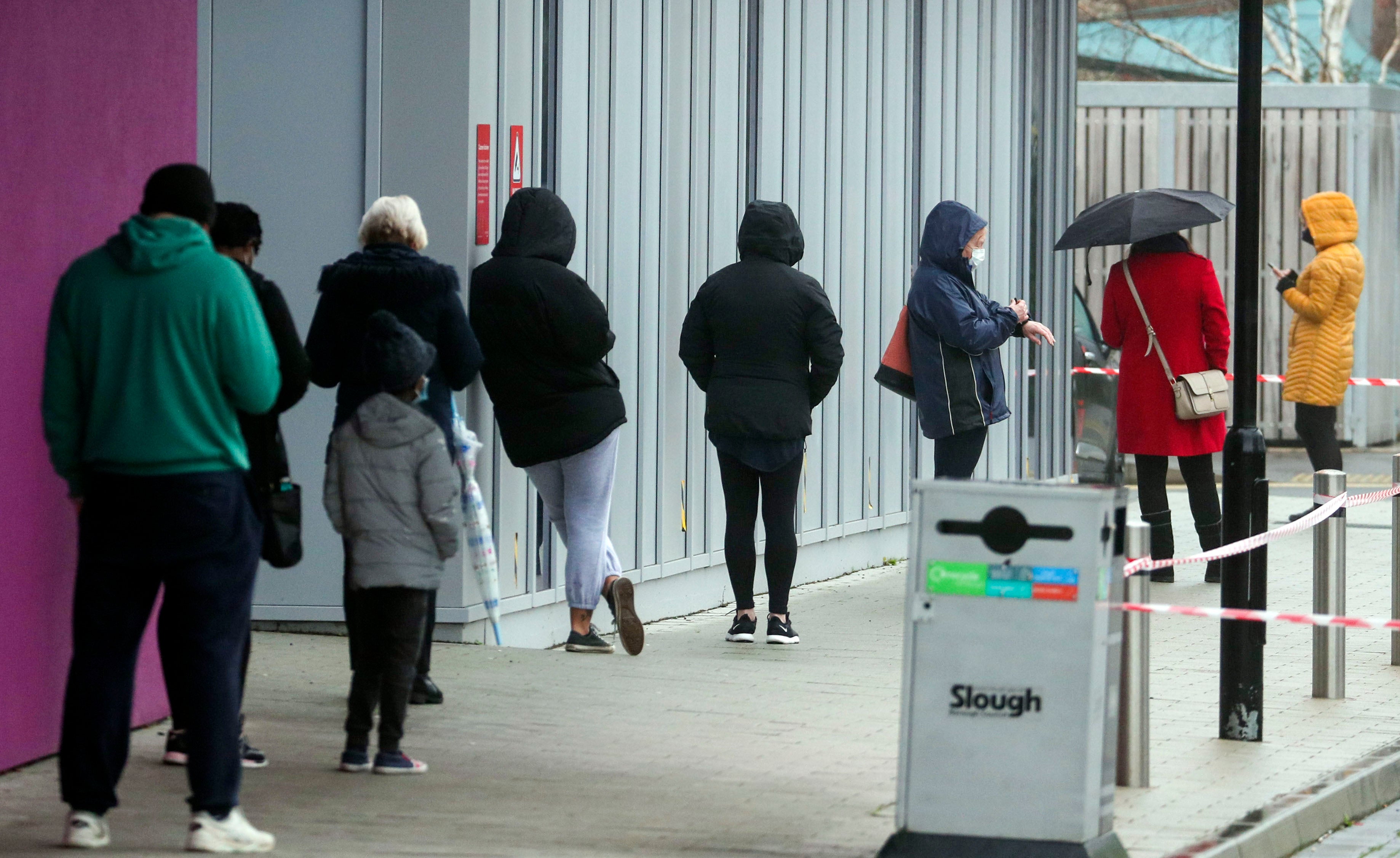 People queue at The Centre in Slough, Berkshire, after a rapid testing hub was opened for locals
