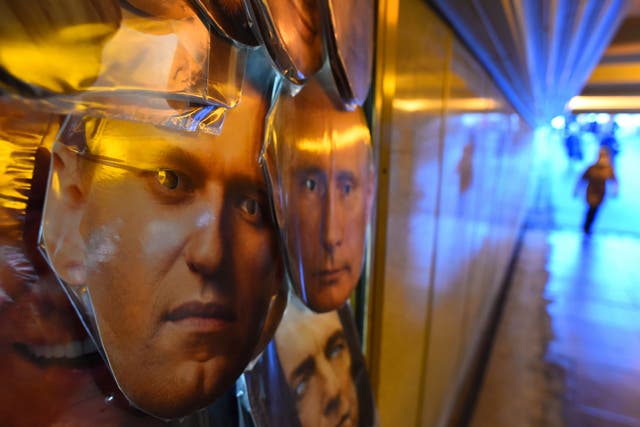 <p>Masks of opposition leader Alexei Navalny and President Vladimir Putin are seen on sale at a souvenir stall in an underground passage in Saint Petersburg&nbsp;</p>