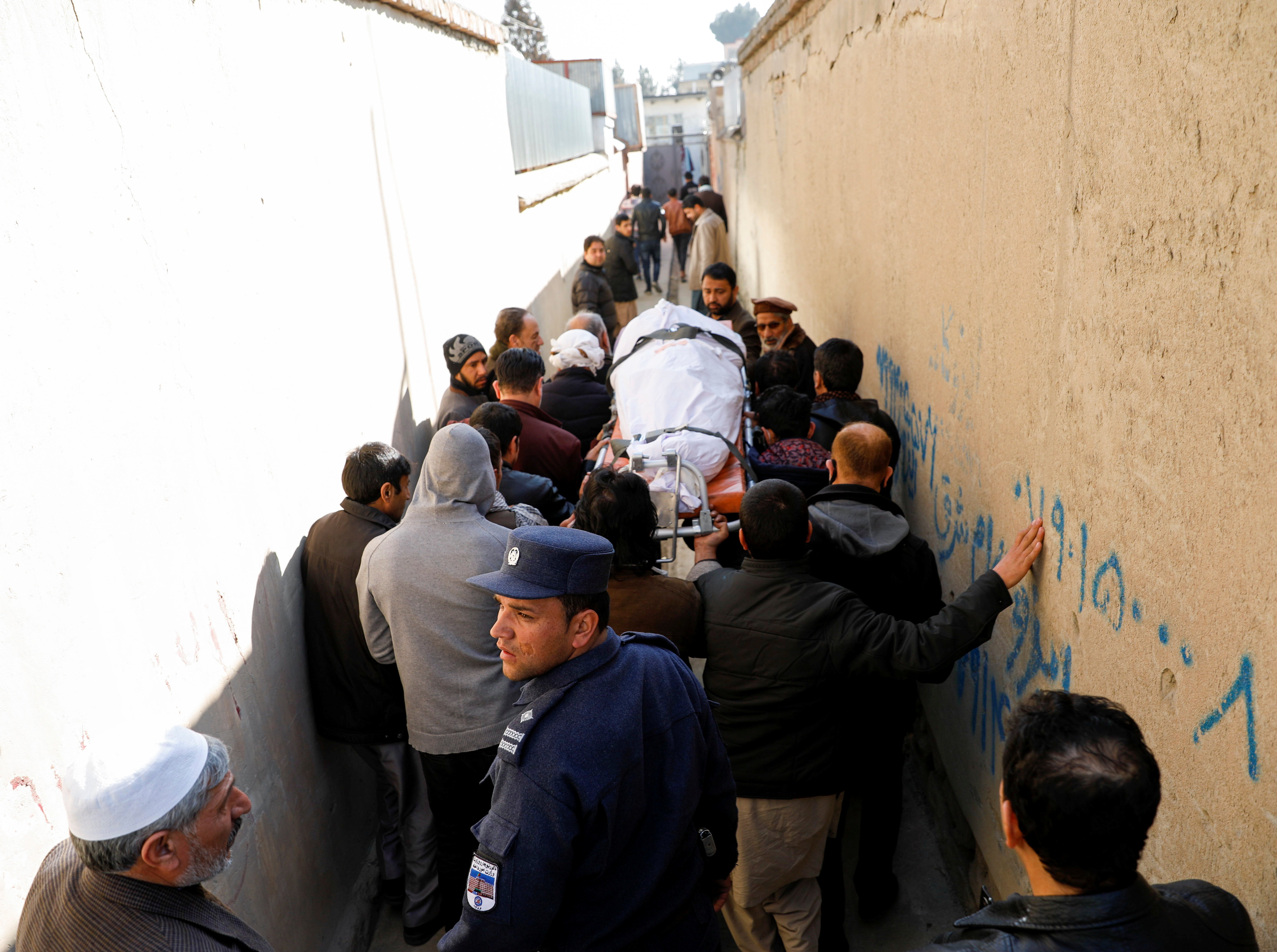 Relatives carry the body of one of female judges shot dead by unknown gunmen in Kabul