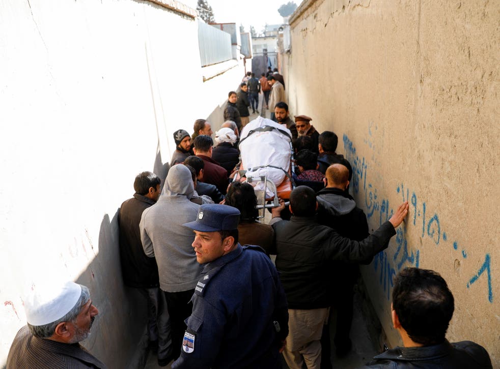 <p>Relatives carry the body of one of female judges shot dead by unknown gunmen in Kabul</p>