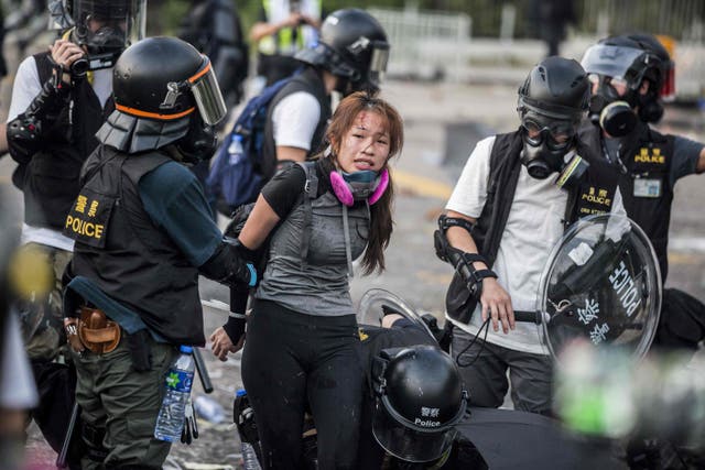 <p>Police detain demonstrators in the Sha Tin district of Hong Kong in 2019</p>