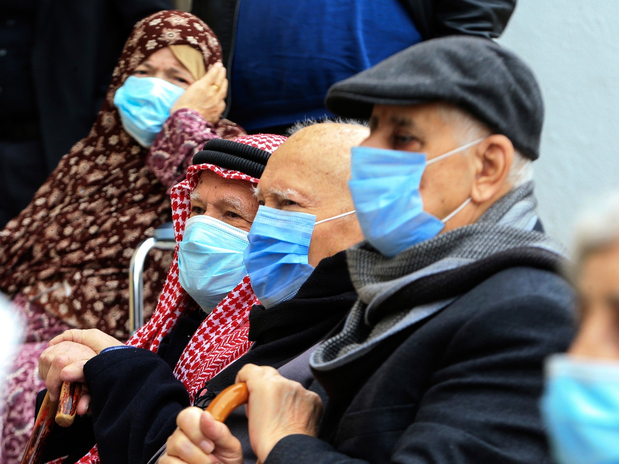 People wait to receive a Pfizer jab at a vaccination centre in Amman, Jordan
