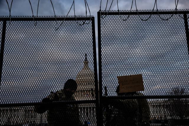 WASHINGTON, DC - JANUARY 17: National Guard soldiers secure a gate to the east front of the U.S. Capitol on the morning of January 17, 2021 in Washington, DC. After last week's riots at the U.S. Capitol Building, the FBI has warned of additional threats in the nation's capital and in all 50 states. According to reports, as many as 25,000 National Guard soldiers will be guarding the city as preparations are made for the inauguration of Joe Biden as the 46th U.S. President. (Photo by Samuel Corum/Getty Images)