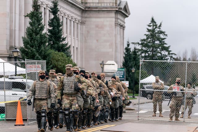 <p>Members of the National Guard leave the perimeter of the Washington State Capitol while providing extra security in Olympia, Washington, USA, 17 January 2021.&nbsp;</p>