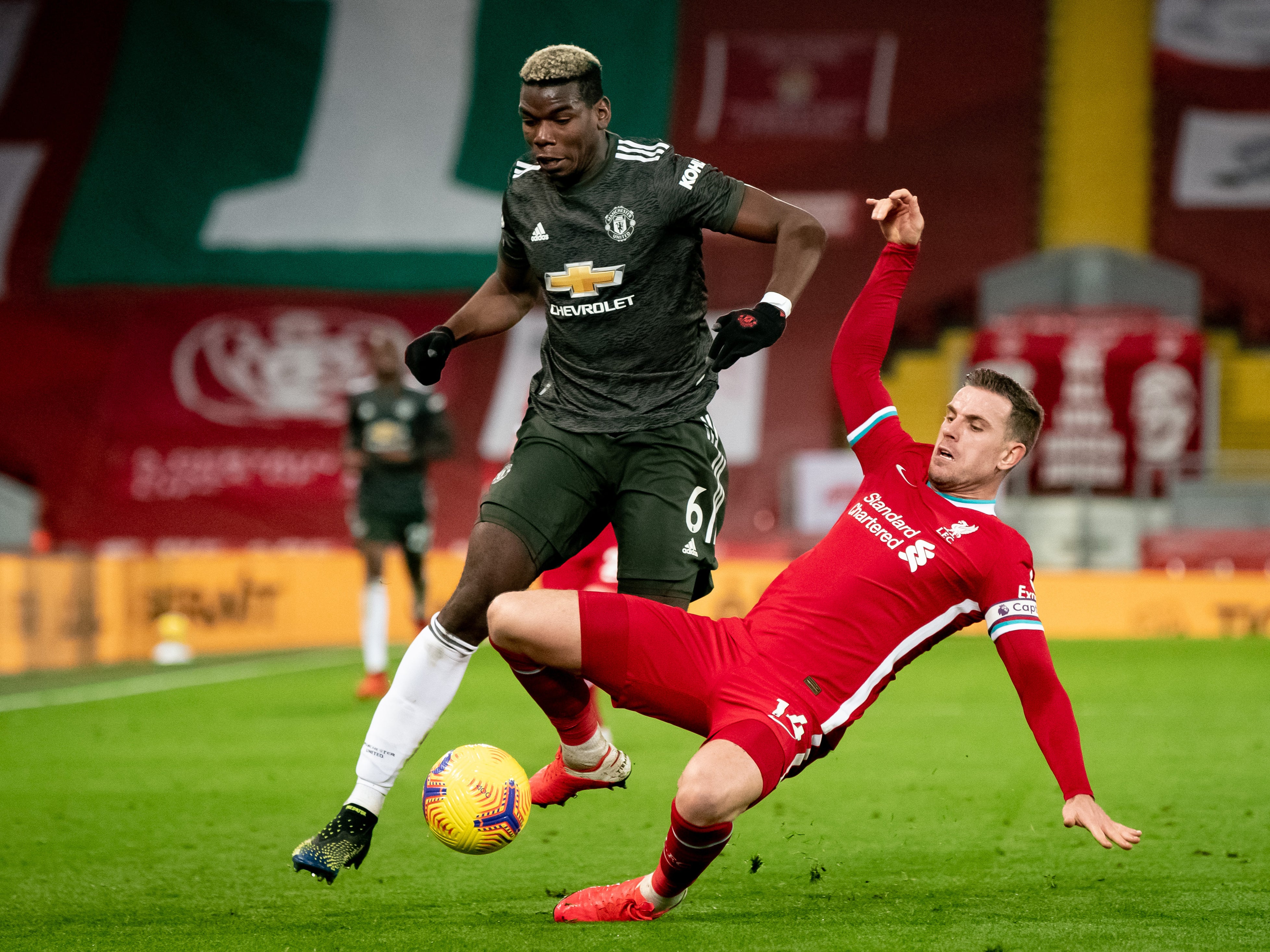 Jordan Henderson challenges Paul Pogba