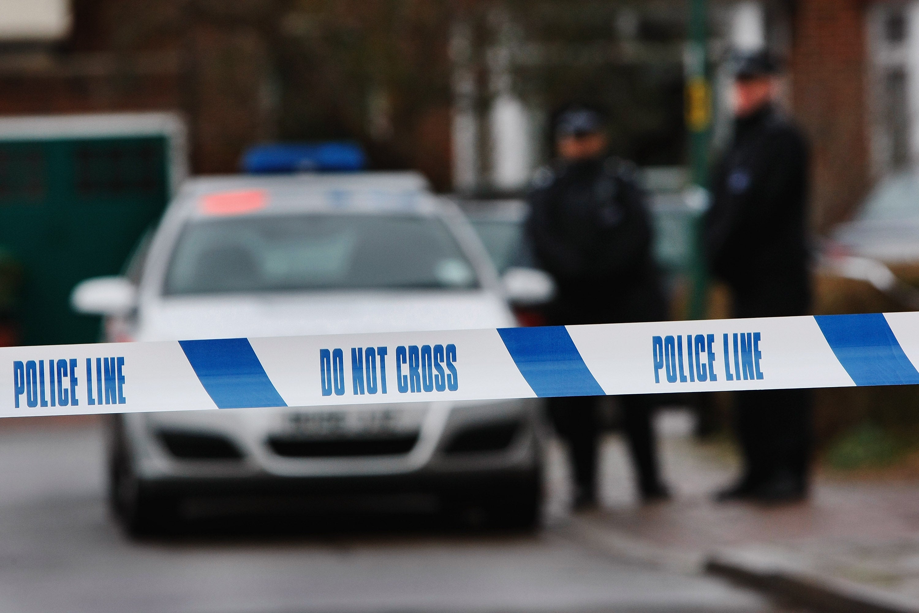 Police tape is pictured as police officers stand guard outside of a house in Edgeware on December 27, 2007 in London, England. A plastic surgeon is facing attempted murder charges in a stabbing incident.