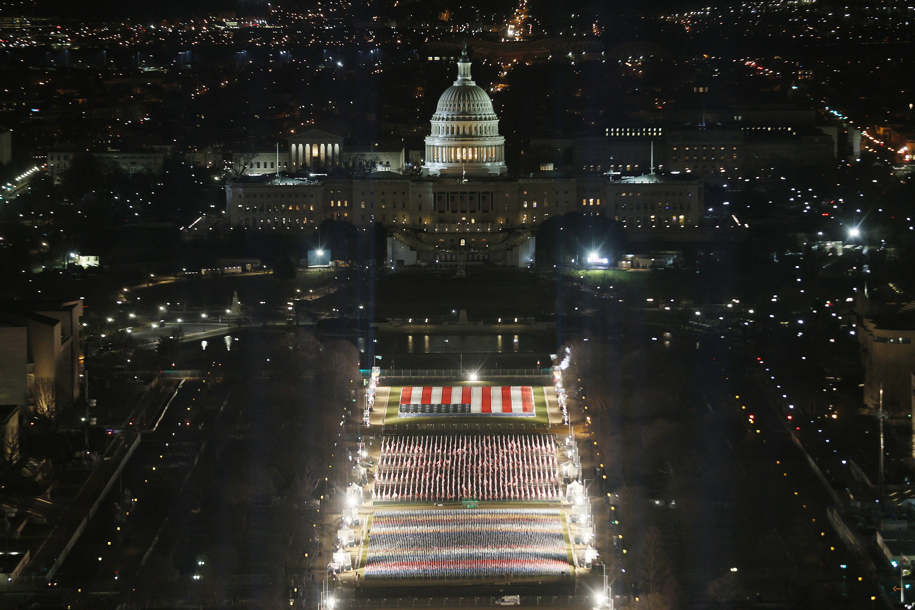 The "Field of Flags" is illuminated on the National Mall as the U.S Capitol Building is prepared for the inauguration ceremonies for President-elect Joe Biden on 18 January &nbsp;2021 in Washington, DC.&nbsp;