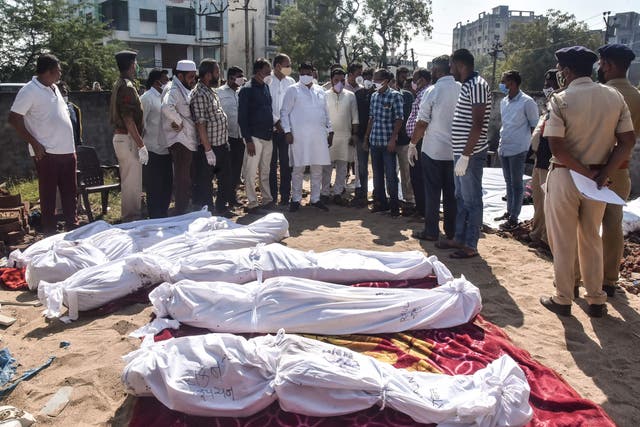 <p>Police personnel and residents gather around the bodies of victims after a truck lost control and ran over them while sleeping in Surat district.</p>