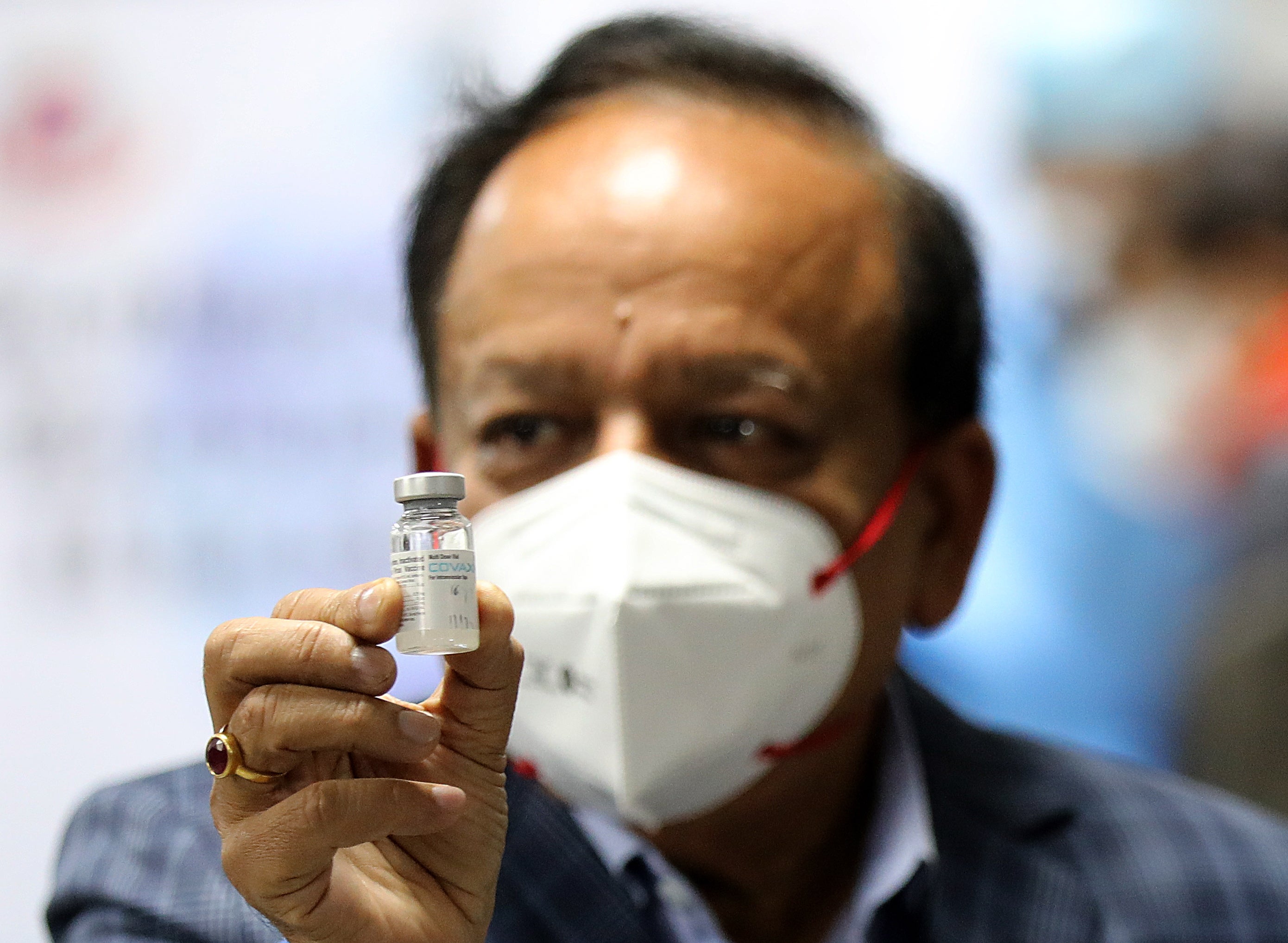 India’s health minister Dr Harsh Vardhan holding Bharat Biotech’s Covid-19 vaccine, Covaxin, during the launch of the vaccination drive on 16 January