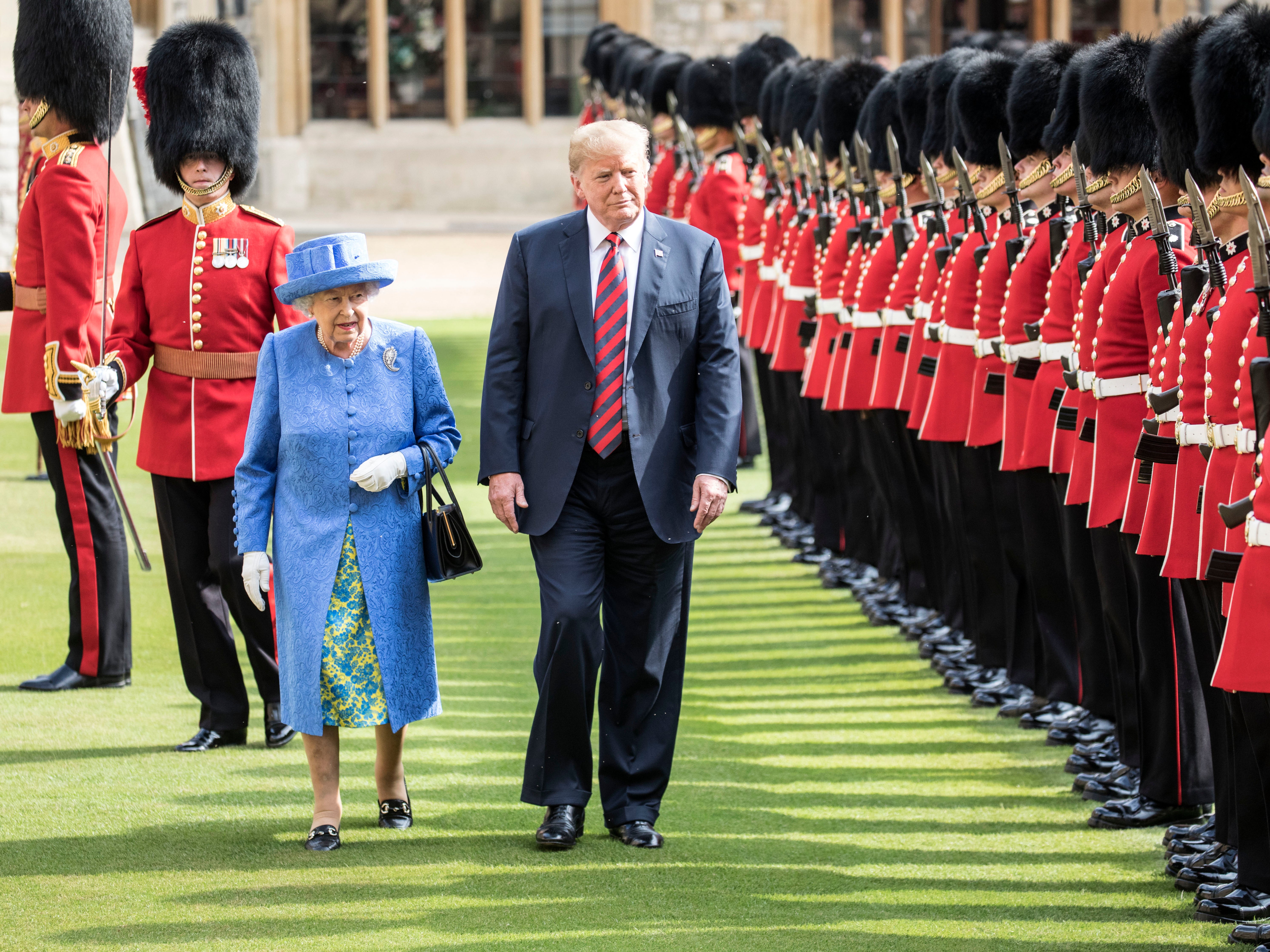 Donald Trump and Queen Elizabeth II inspect a guard of honour at Windsor Castle, in July 2018. He caused a brief breach of protocol by walking in front of her