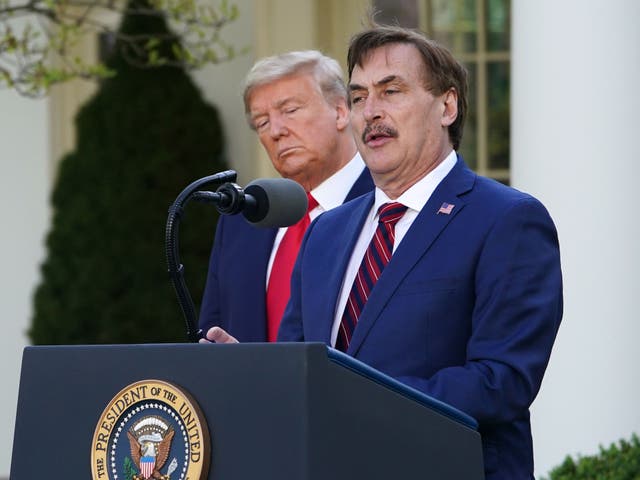 <p>US President Donald Trump listens as Michael J. Lindell, CEO of MyPillow Inc., speaks during the daily briefing on the novel coronavirus, Covid-19, in the Rose Garden of the White House in Washington, DC, on 30 March 2020</p>