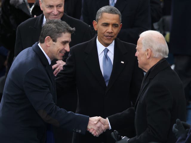 Richard blanco is greeted by then-Vice President Joe Biden and then-President Barack Obama after reciting his poem during the presidential inauguration on 21 January 2013 at the US Capitol in Washington, DC