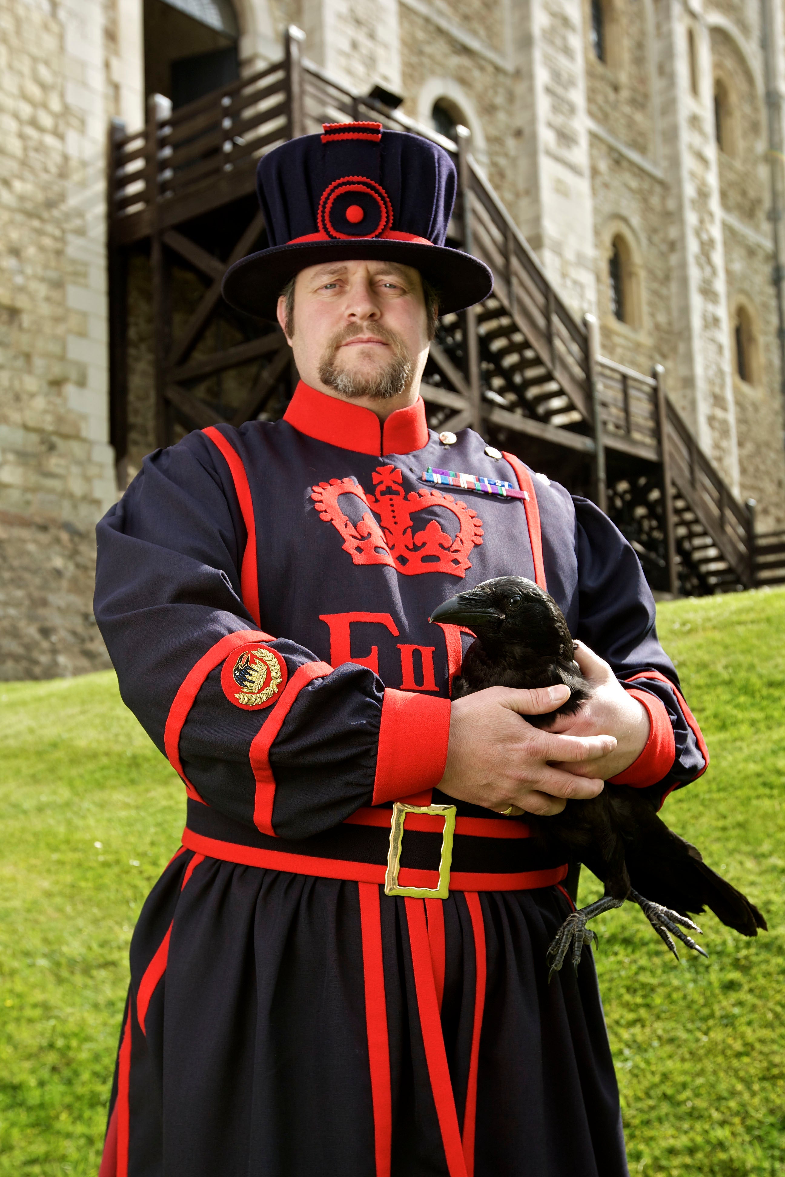 Ravenmaster Chris Skaife is holding one of the Tower’s ravens