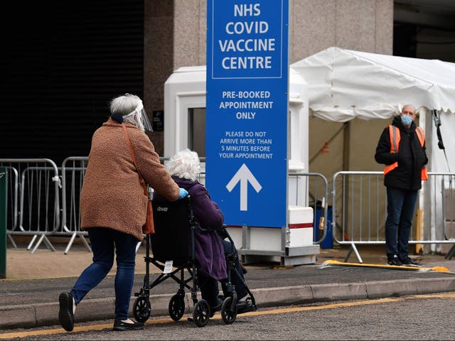 An elderly person in a wheelchair attends a Covid-19 vaccination centre in Wembley, northwest London, on Tuesday