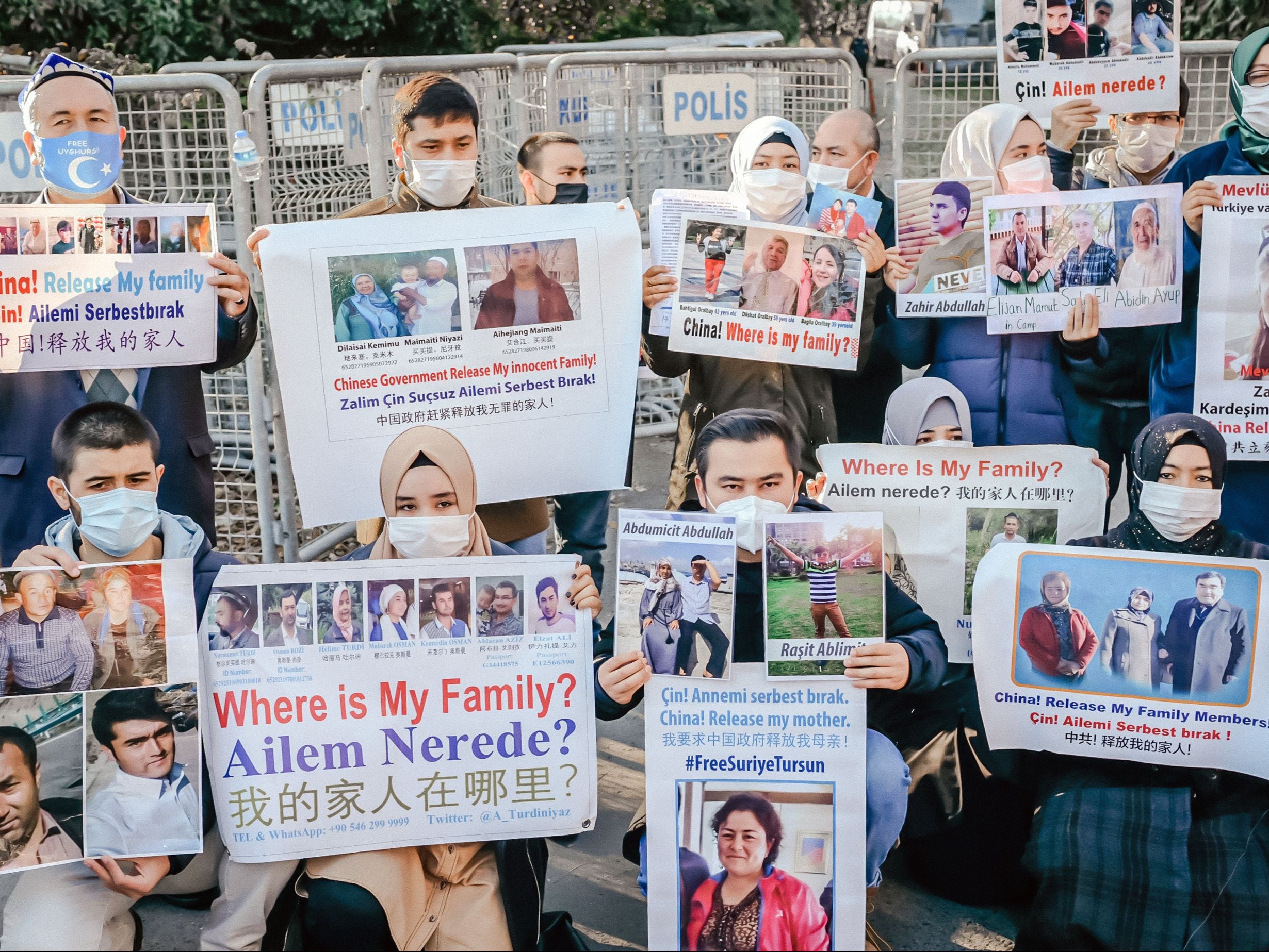 Members of the Muslim Uighur minority hold placards as they demonstrate in front of the Chinese consulate in Istanbul