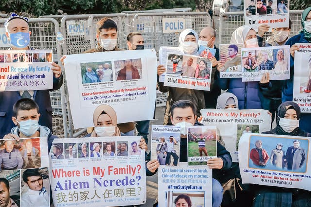 <p>Members of the Muslim Uighur minority hold placards as they demonstrate in front of the Chinese consulate in Istanbul</p>