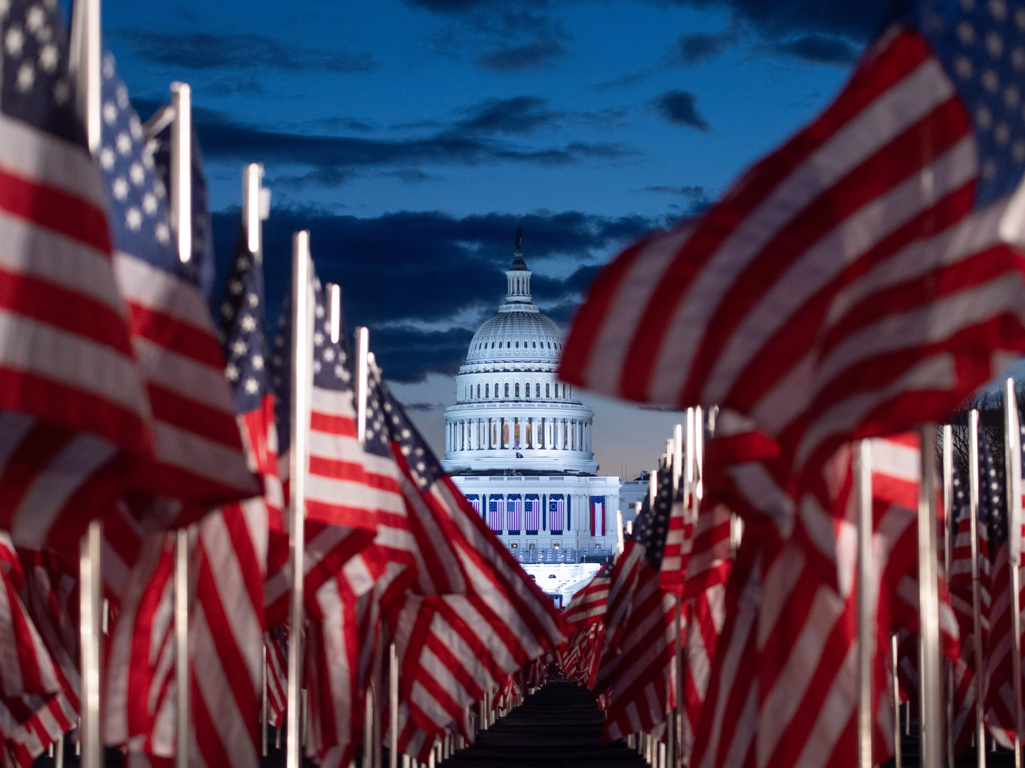 Nearly 200,000 American flags are seen in the early hours of Inauguration Day on the National Mall as part of a ‘Field of Flags’ exhibition to represent those not able to attend due to the Covid-19 pandemic