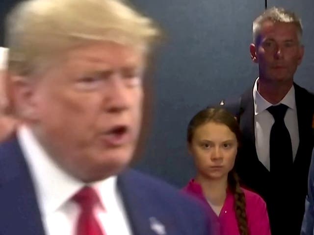 <p>Greta Thunberg watches as President Donald Trump enters the United Nations to speak with reporters in a still image from video taken in New York City, on 23 September 2019</p>