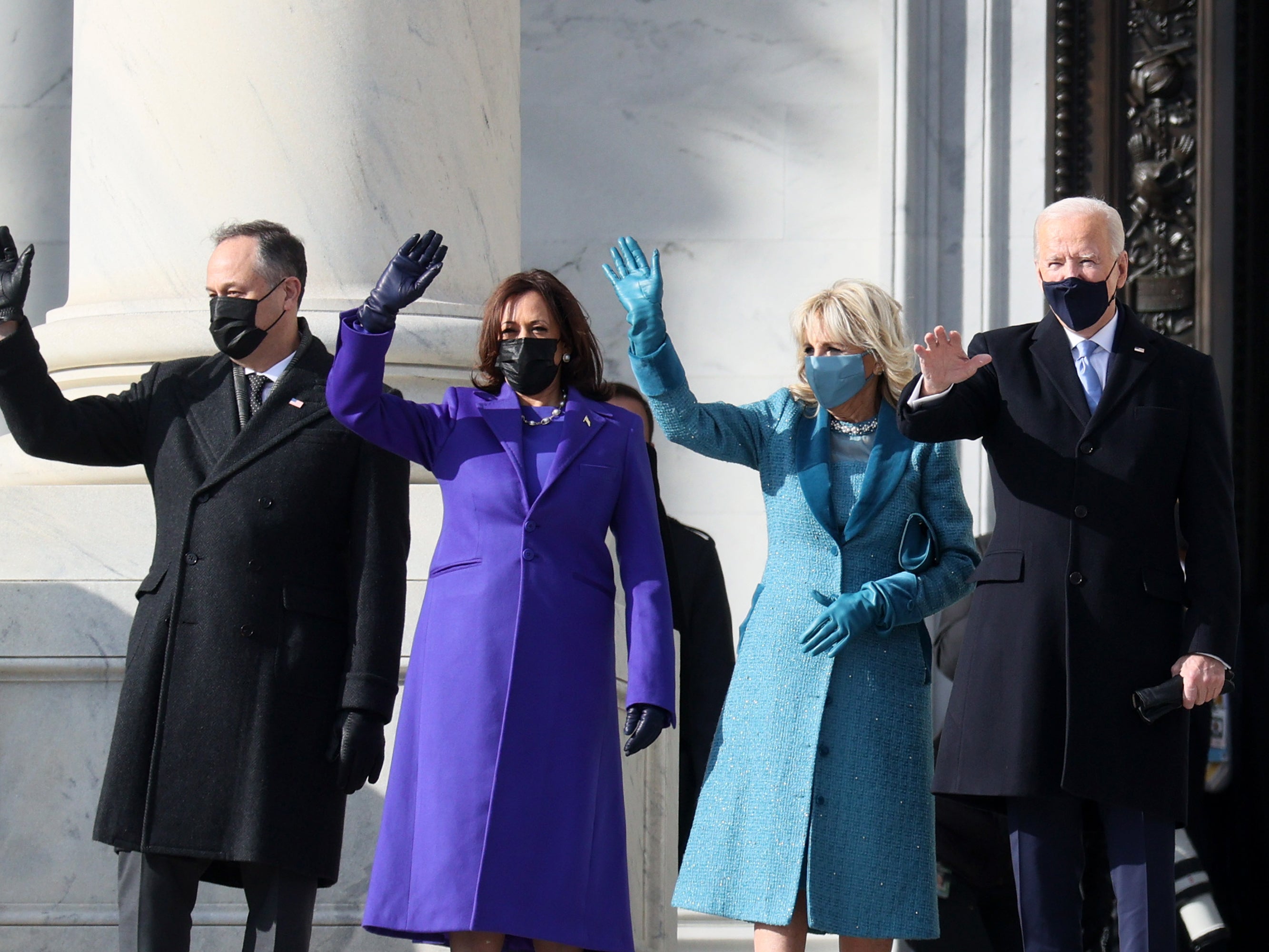 Joe Biden, Kamala Harris, Jill Biden, and Doug Emhoff wave as they arrive on the East Front of the Capitol for the inauguration ceremony