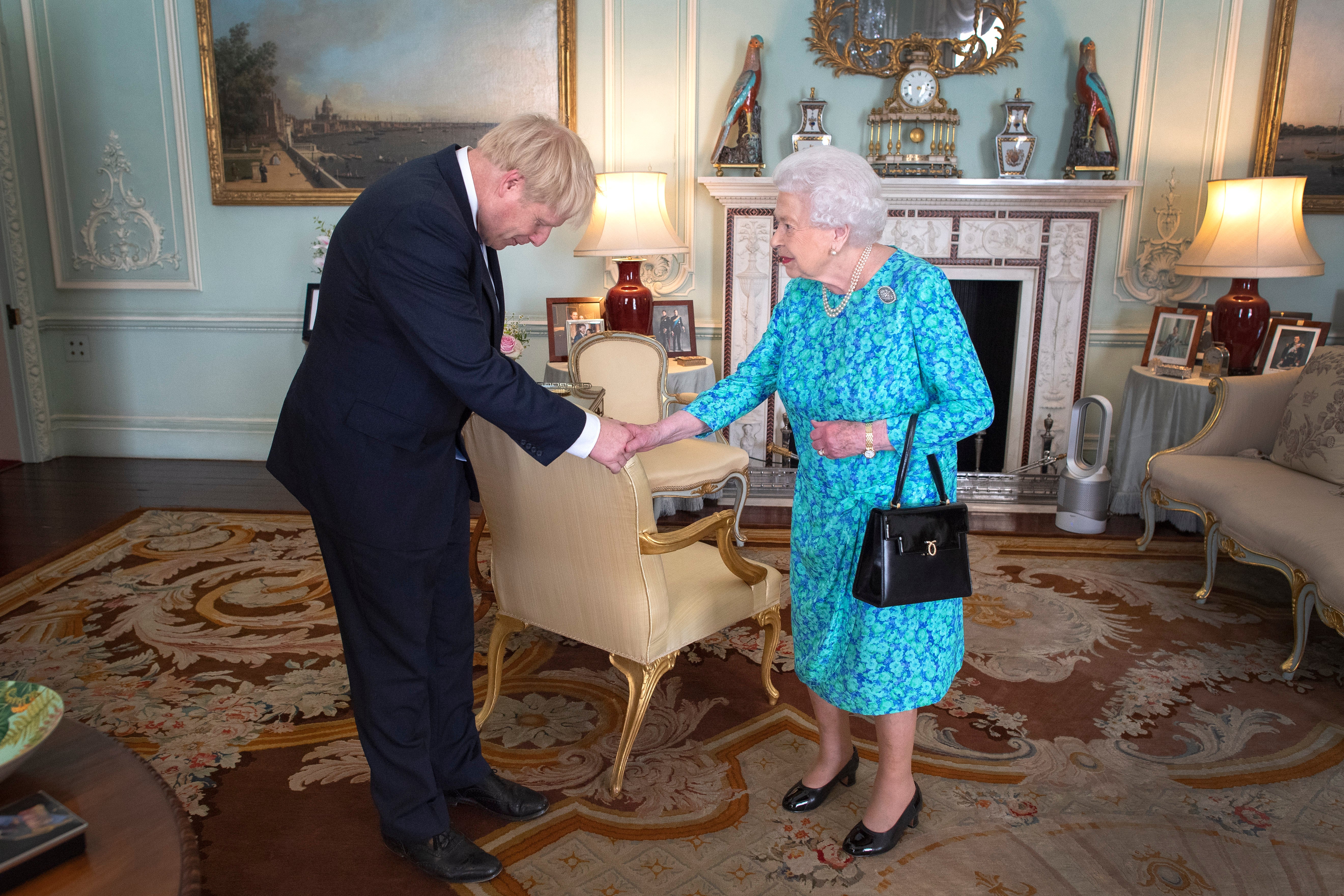The Queen shakes hands with her 14th prime minister, Boris Johnson
