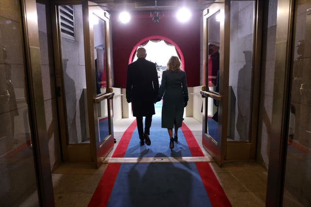 President Joe Biden and First Lady Jill Biden walk onto the front balcony of the US Capitol during his inauguration ceremony.