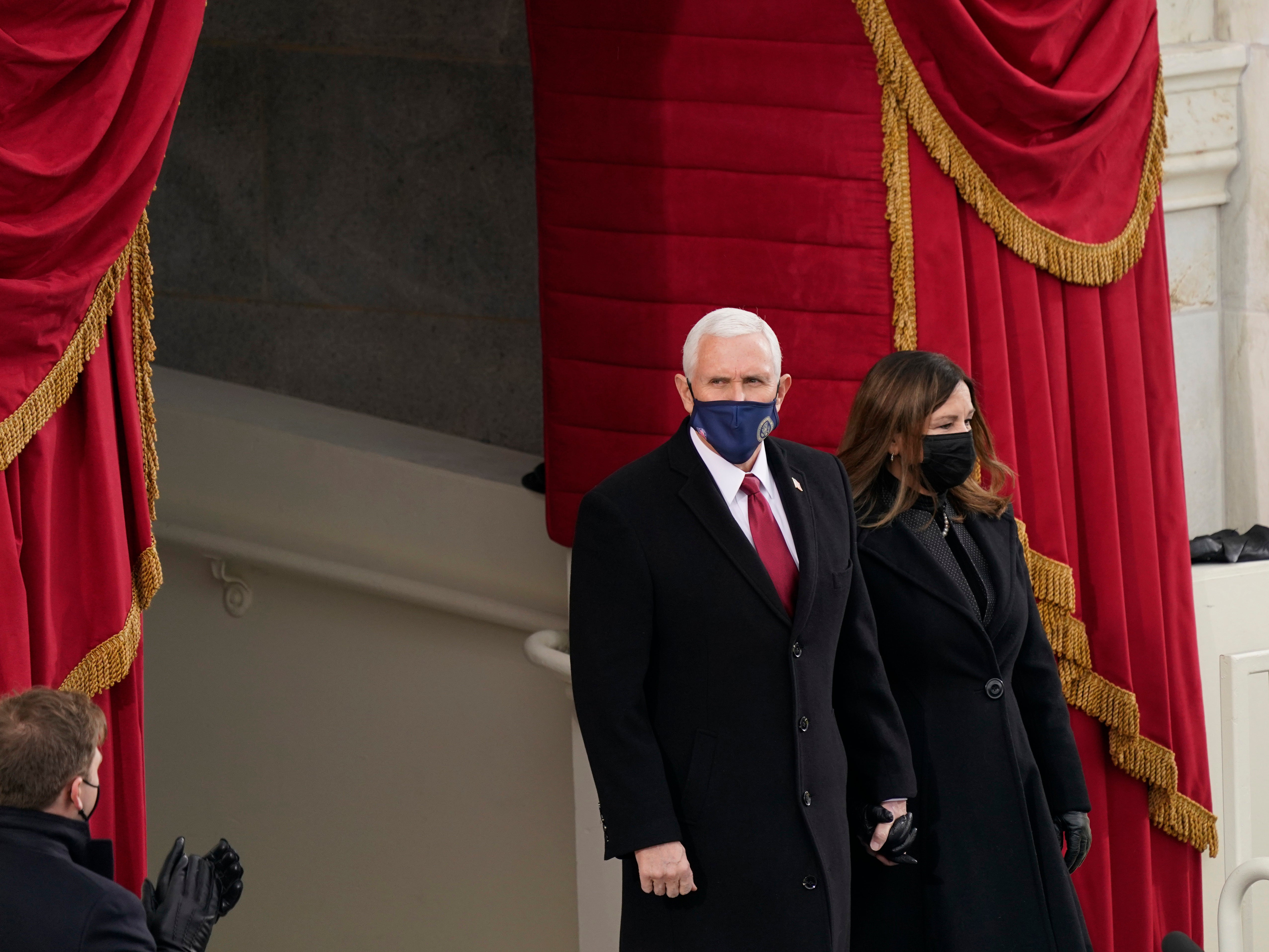 Vice President Mike Pence and Karen Pence arrive at the inauguration of Joe Biden on the West Front of the US Capitol. Mr Pence is attending the inauguration ceremony despite the absence of President Donald Trump, who left Washington before the ceremony began