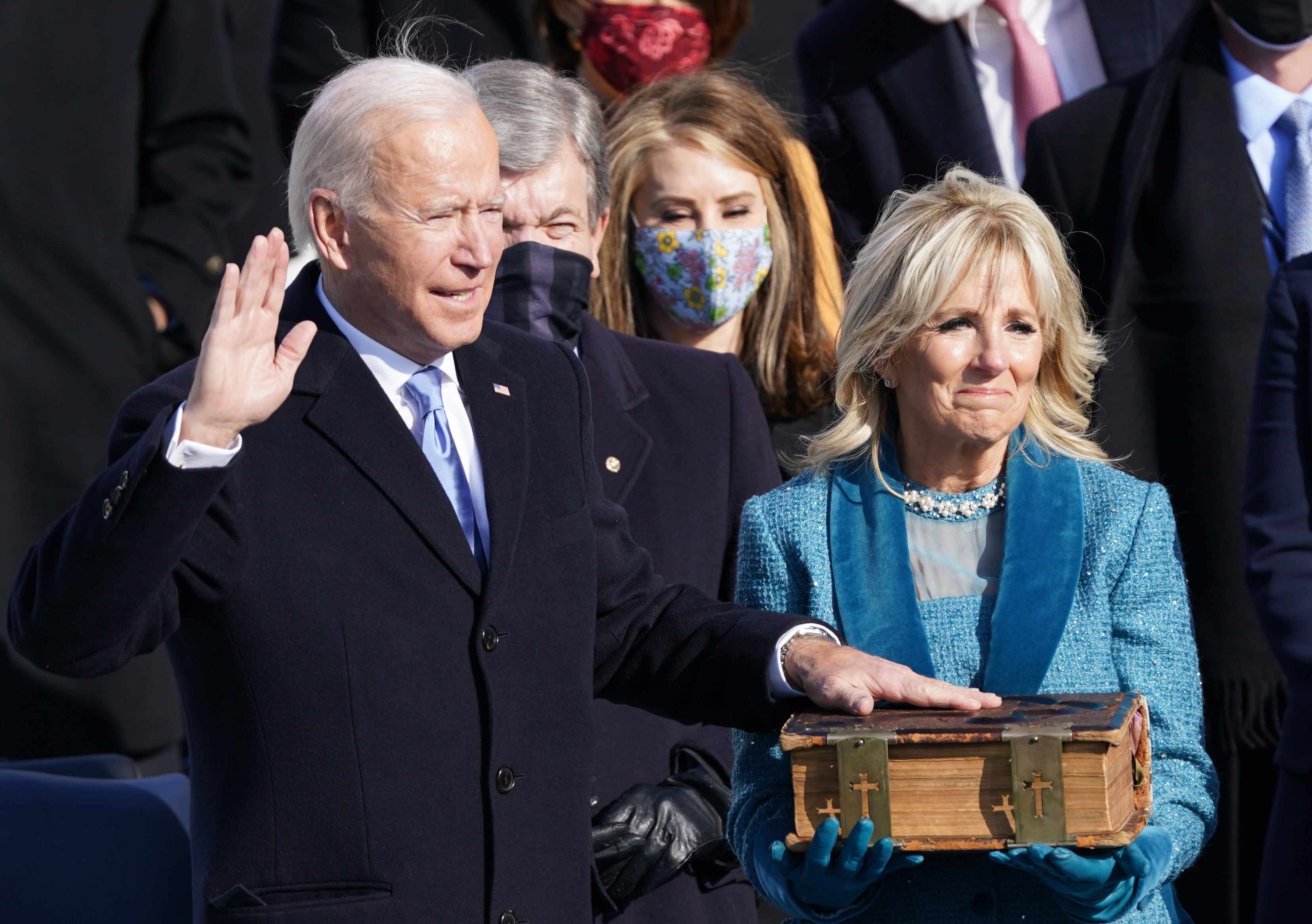 Joe Biden is sworn in as the 46th president of the United States as his wife Jill Biden holds the bible. The president welcomed a ‘day of history and hope’ after taking Oath of Office saying: ‘This is America’s day. This is democracy’s day. A day of history and hope’