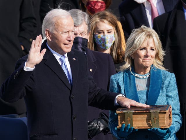  Joe Biden is sworn in as the 46th President of the United States as his wife Jill Biden holds the bible. The president welcomed a ‘day of history and hope’ after taking Oath of Office saying: ‘This is America’s day. This is democracy’s day. A day of history and hope’