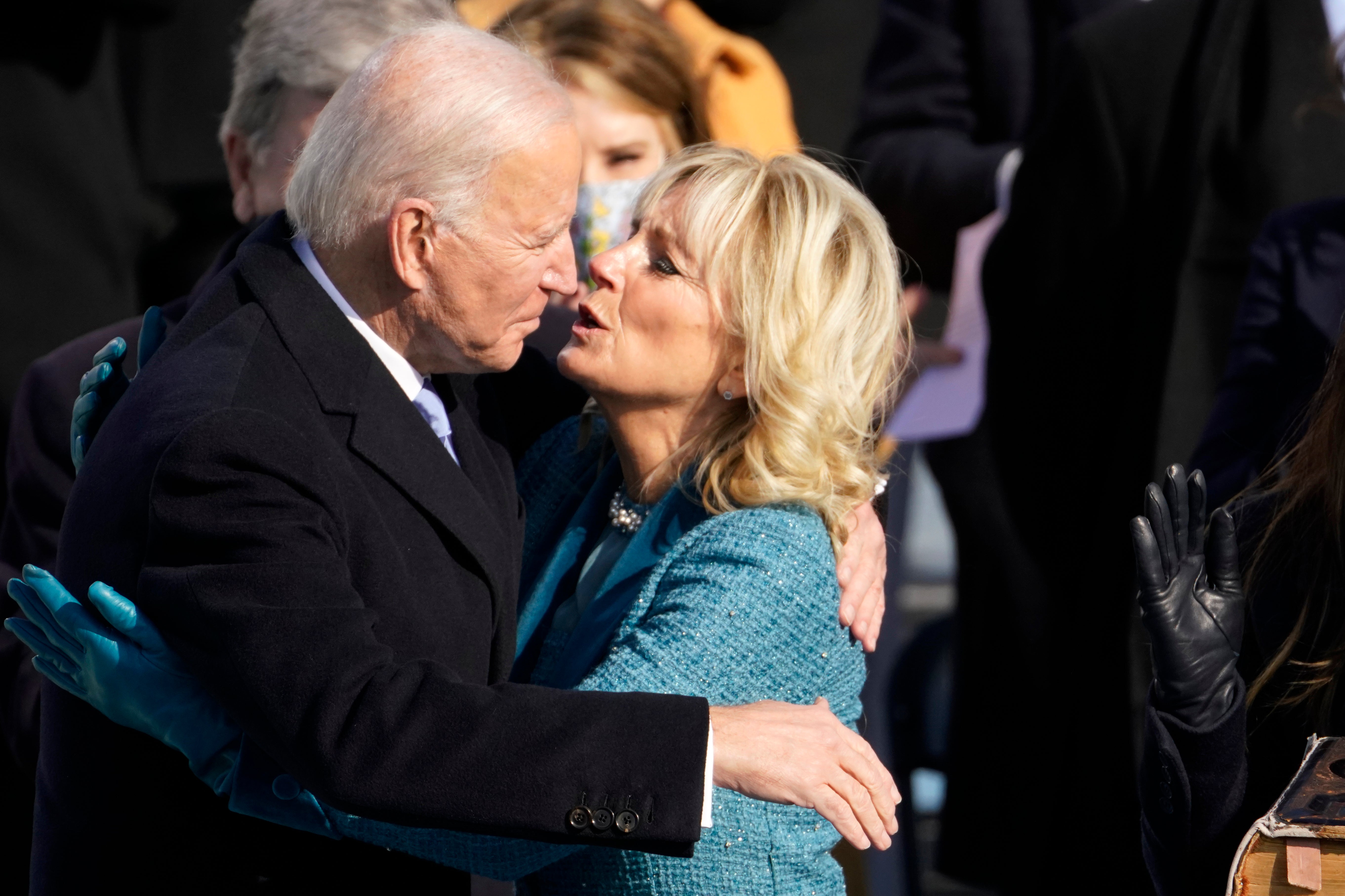Joe Biden is embraced by first lady Jill Biden after being sworn in as president