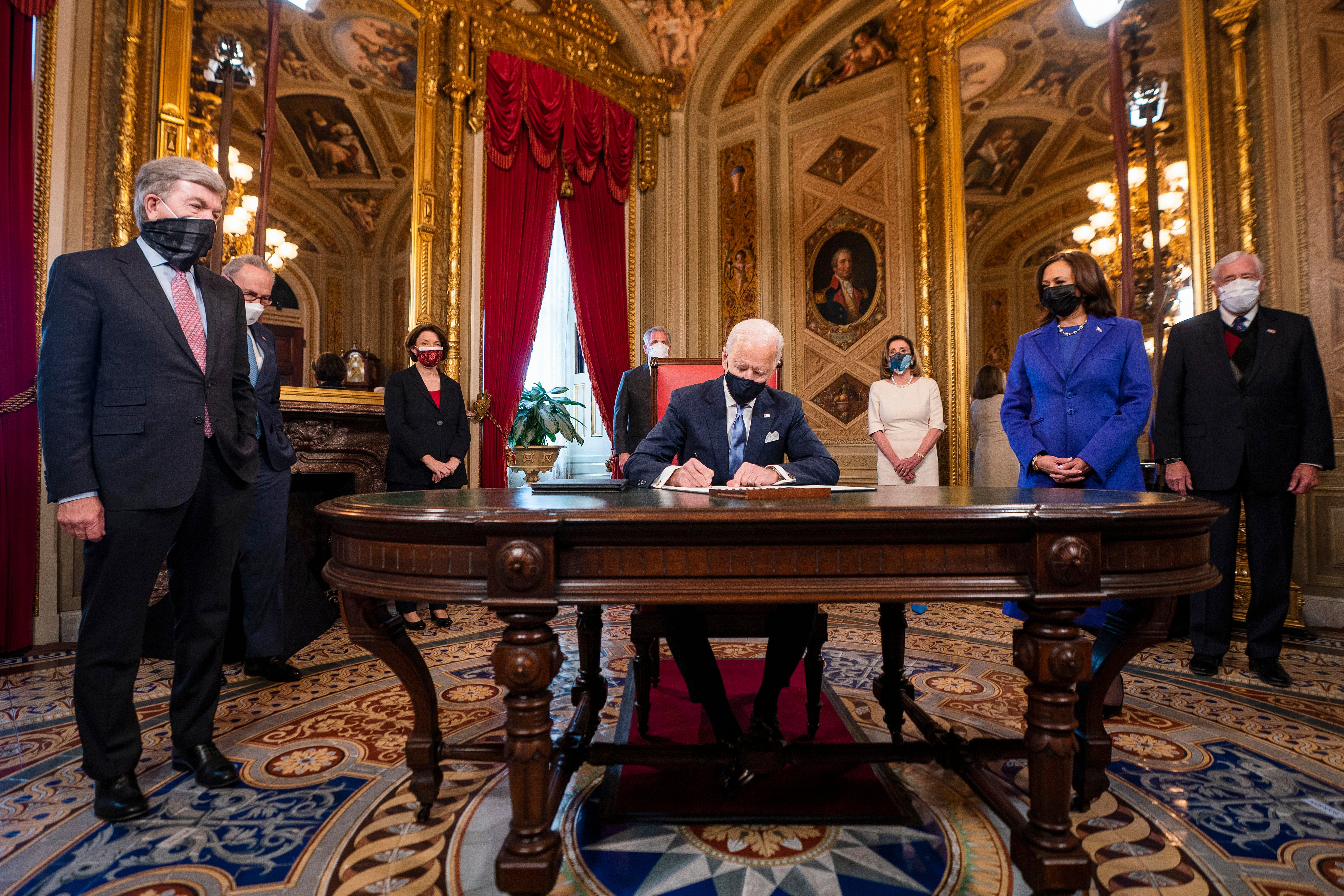 Joe Biden signs three documents including an inauguration declaration, cabinet nominations, and sub-cabinet nominations in the President’s Room at the Capitol&nbsp;