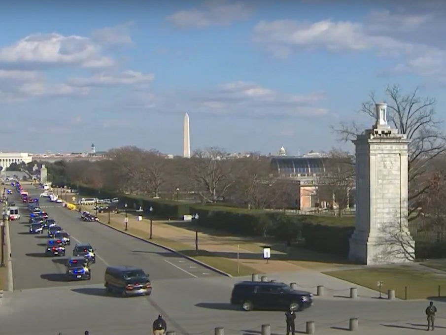 President Joe Biden is driven through Washington with a military escort to Arlington Cemetery ahead of the wreath-laying ceremony as streets are lined with members of the military