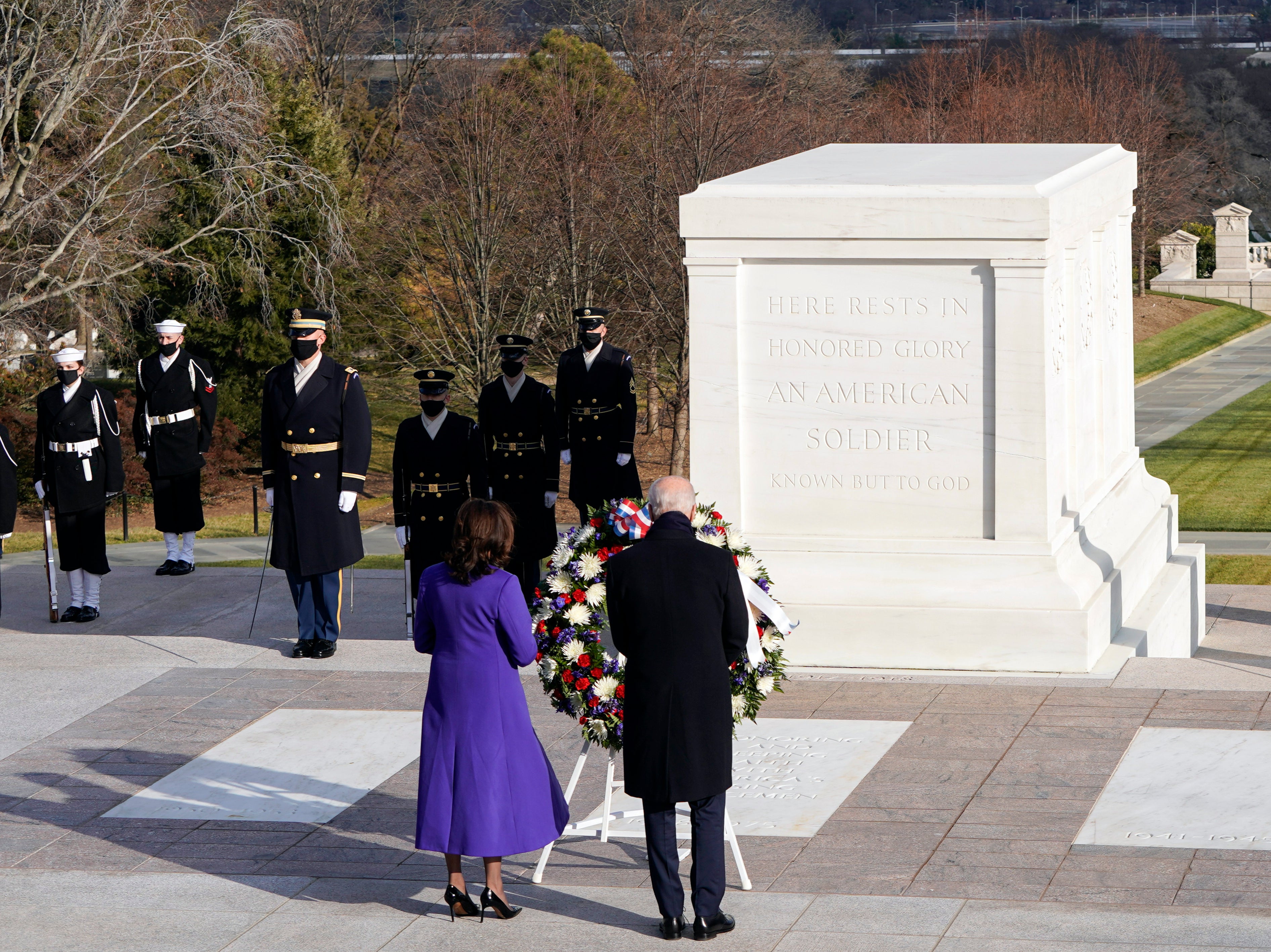 Joe Biden and Kamala Harris lay a wreath at the Tomb of the Unknown Soldier at the Arlington National Cemetery following the inauguration ceremony