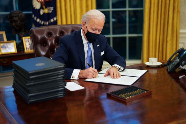 <p>Joe Biden at work in the Oval Office</p>