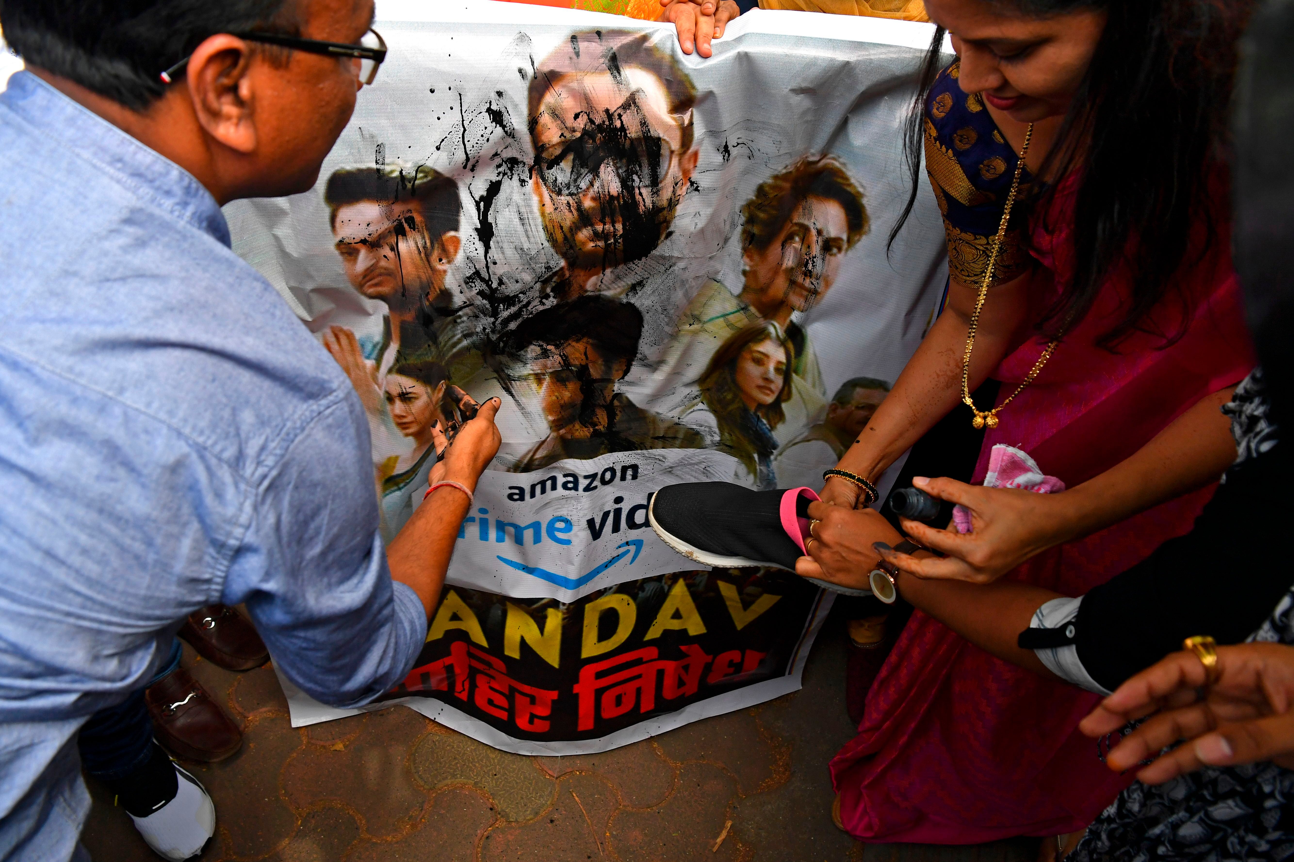 Supporters of India's ruling Bharatiya Janata Party (BJP) pour ink and beat a poster with footwear during a protest against a new web series 'Tandav', in Mumbai on 18 January 2021
