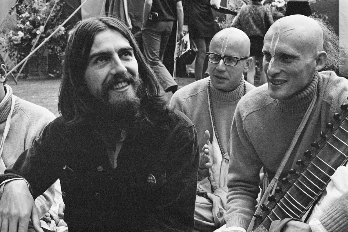 Harrison with members of the Hare Krishna movement, which was an inspiration for his first UK single