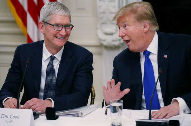 Tim Cook laughs with Donald Trump at the White House in 2019