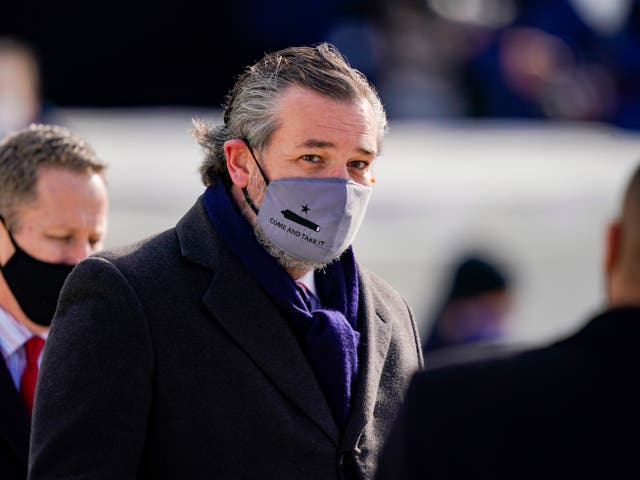 <p>Ted Cruz (C) (R-TX), wearing a face mask that reads “Come and Take It”, arrives to the inauguration of Joe Biden on the West Front of the US Capitol on 20 January 2021 in Washington, DC</p>