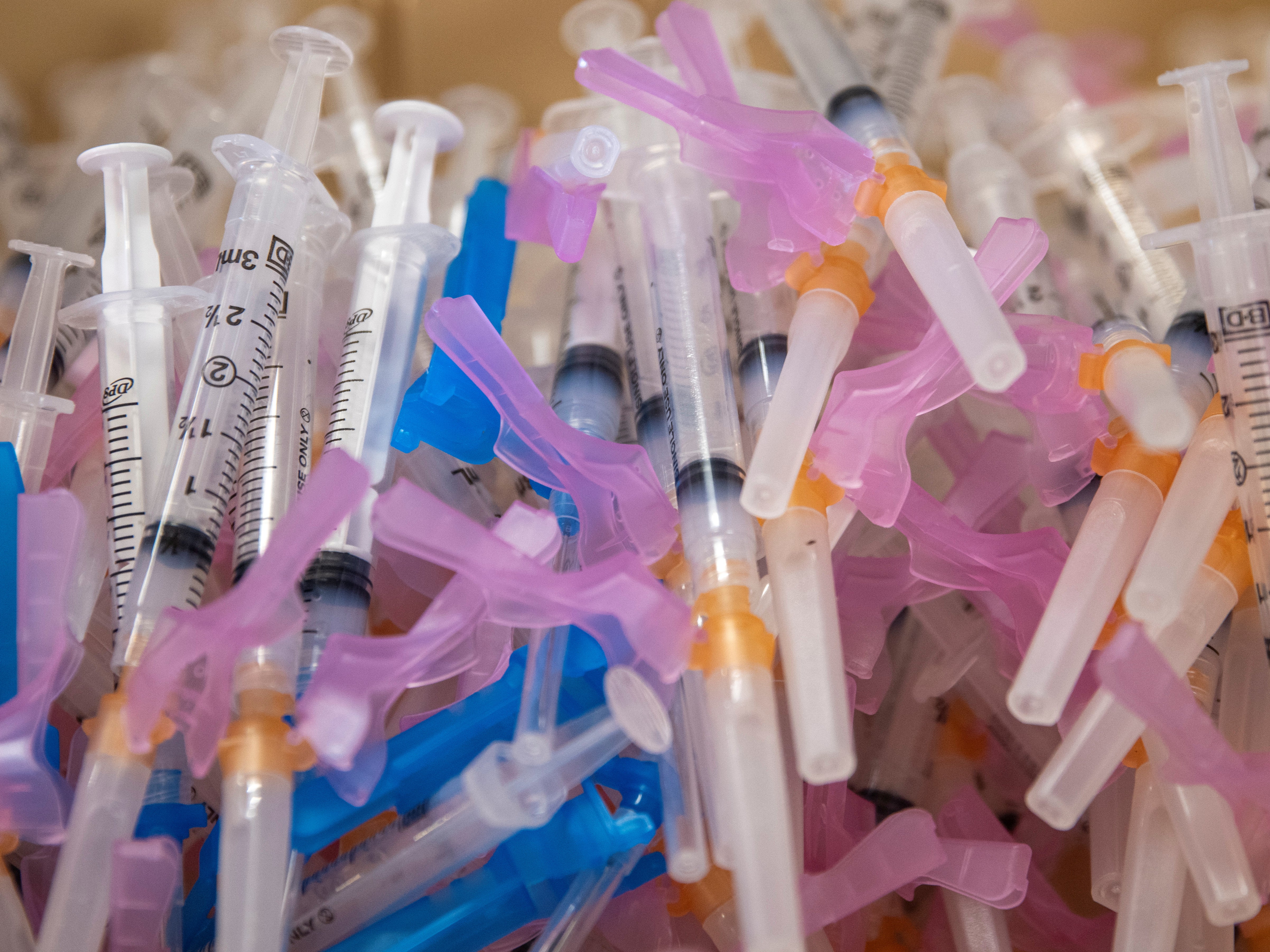 <p>Syringes filled with the Moderna vaccine await patients at a vaccination super station in California</p>
