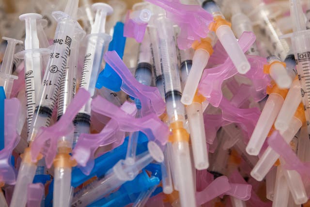 <p>Syringes filled with the Moderna vaccine await patients at a vaccination super station in California</p>