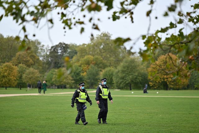 <p>Police wear face masks as they patrol a park</p>