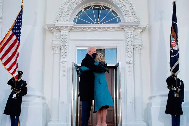 <p>US President Joe Biden hugs First Lady Jill Biden as they arrive at the White House in Washington, DC, on 20 January, 2021</p>
