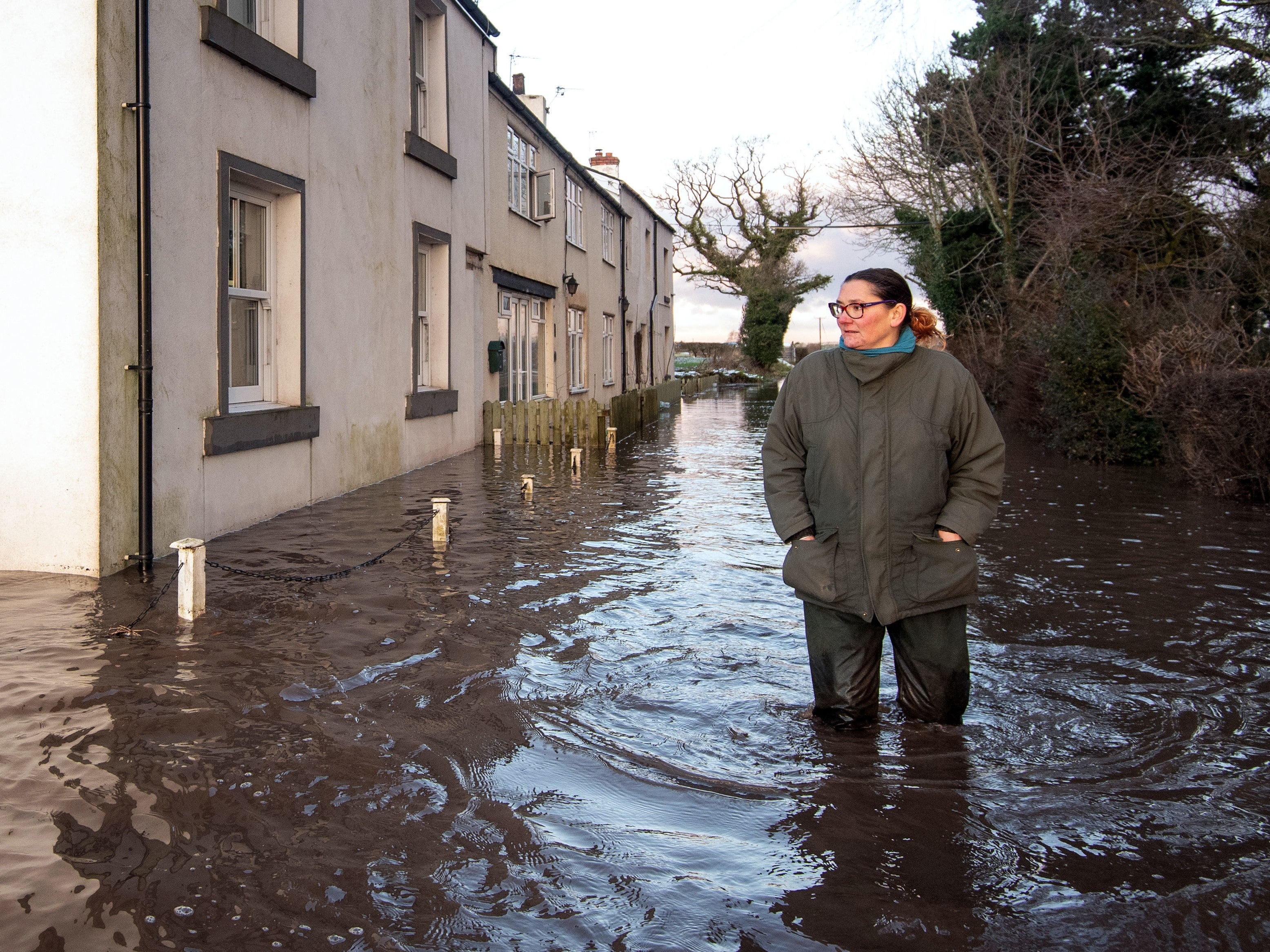 Gabrielle Burns-Smith outside her flooded home on the outskirts in Lymm