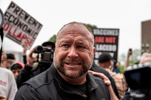 <p>Infowars founder Alex Jones interacts with supporters at the Texas State Capital building on 18 April 2020 in Austin, Texas</p>