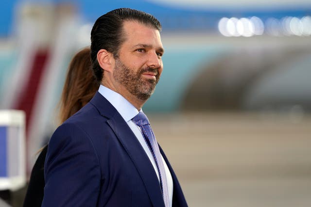 Donald Trump Jr waits for President Donald Trump and First Lady Melania Trump to arrive and board Air Force One 