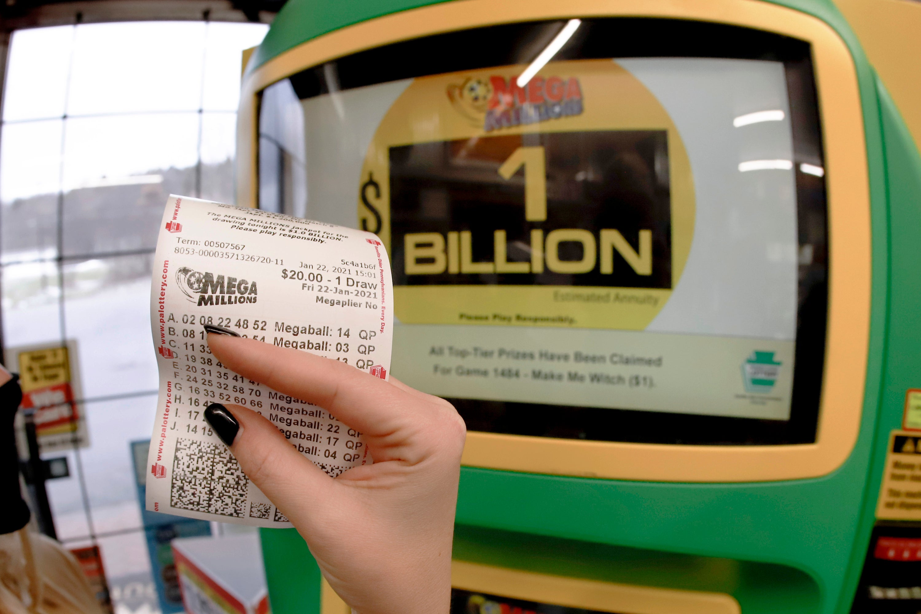<p>Una mujer muestra un boleto para la lotería Mega Millions adquirido en una máquina de venta en la tienda Smoker Friendly, el 22 de enero de 2021, en Cranberry Township, Pensilvania.&nbsp;</p>