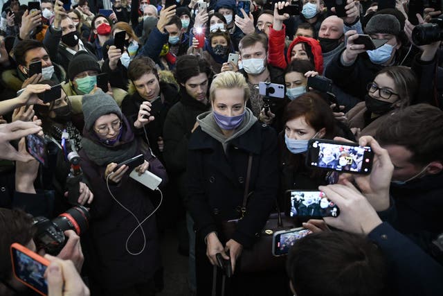 <p>Yulia surrounded by people as she leaves Moscow’s Sheremetyevo airport after her husband’s arrest earlier this month</p>