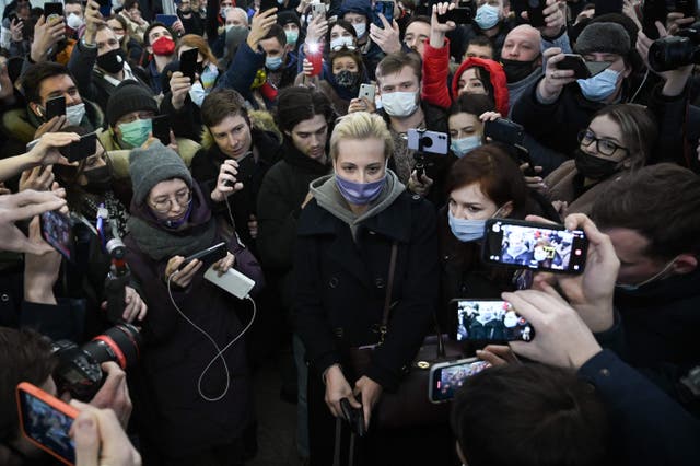 <p>Yulia surrounded by people as she leaves Moscow’s Sheremetyevo airport after her husband’s arrest earlier this month</p>