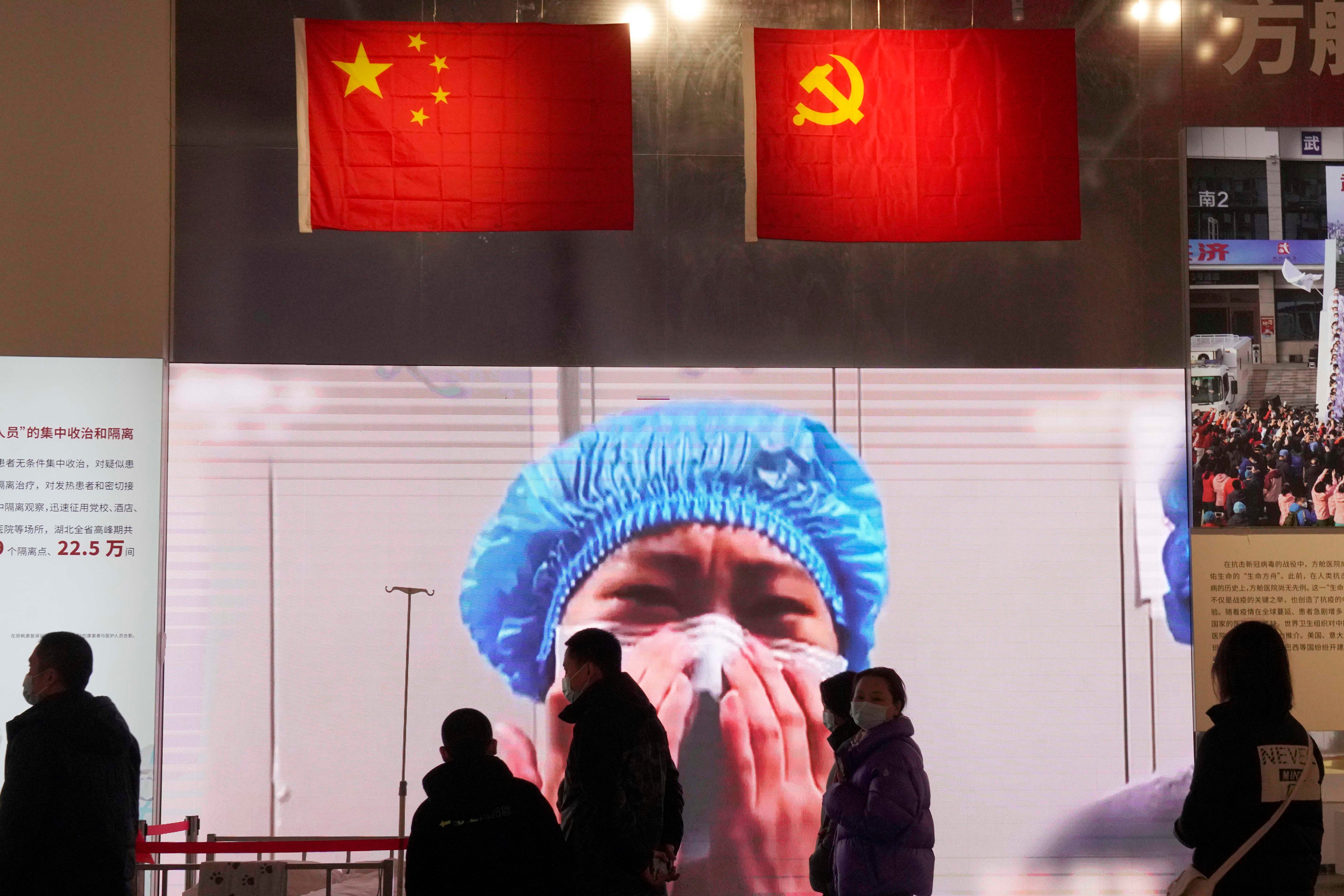 Residents attend an exhibition on the city's fight against the coronavirus in Wuhan