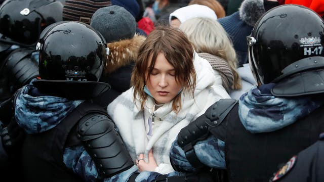 Law enforcement officers detain a woman during a rally in support of jailed Russian opposition leader Alexei Navalny in Moscow, Russia 