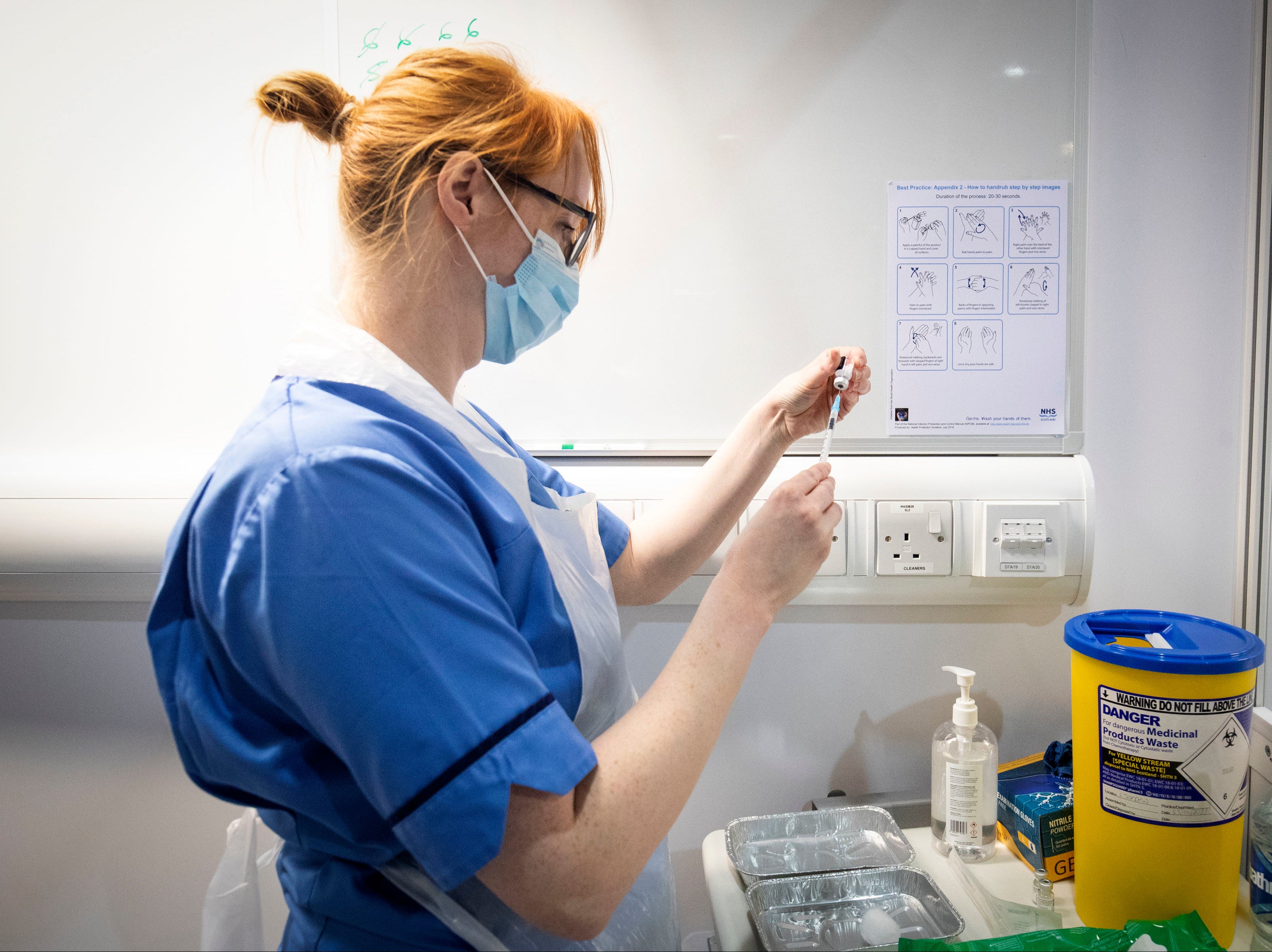 Nurse Eleanor Pinkerton prepares a coronavirus vaccine 